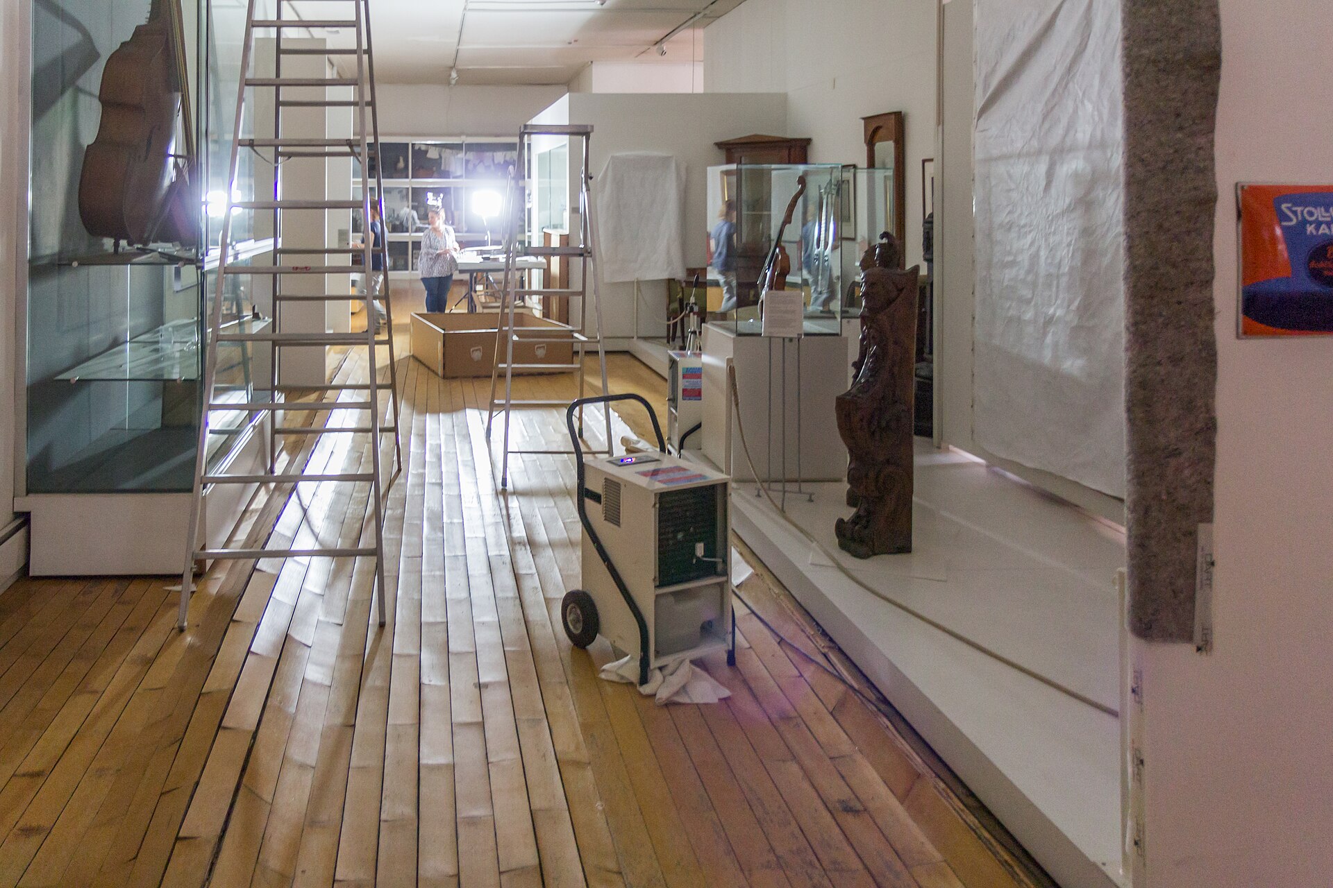 Real commercial dehumidifiers drying water-damaged parquet flooring